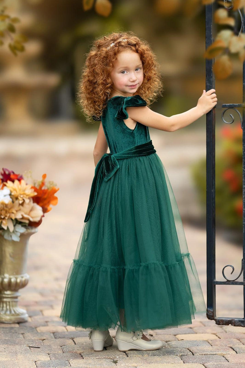 Side view of forest green velvet flower girl dress with closed back and full skirt
