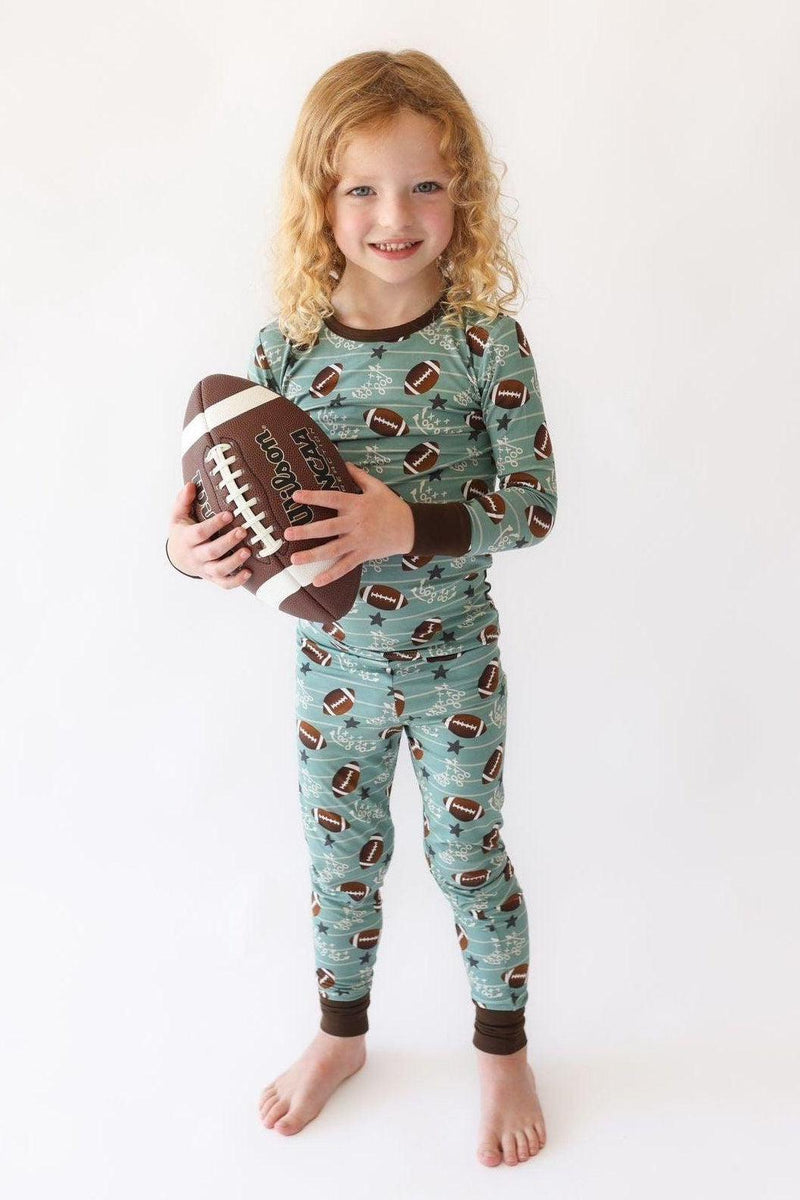 Toddler wearing Football Fans bamboo two-piece pajama set with football print