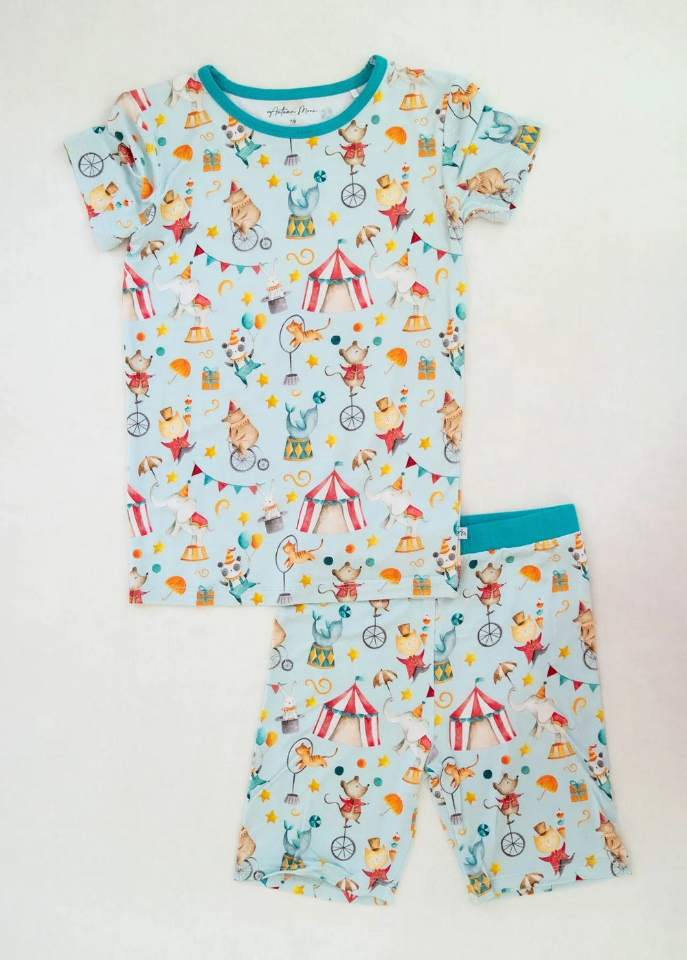 Flat lay of Take Me to the Circus bamboo two-piece kids pajamas with short sleeve top and matching shorts.