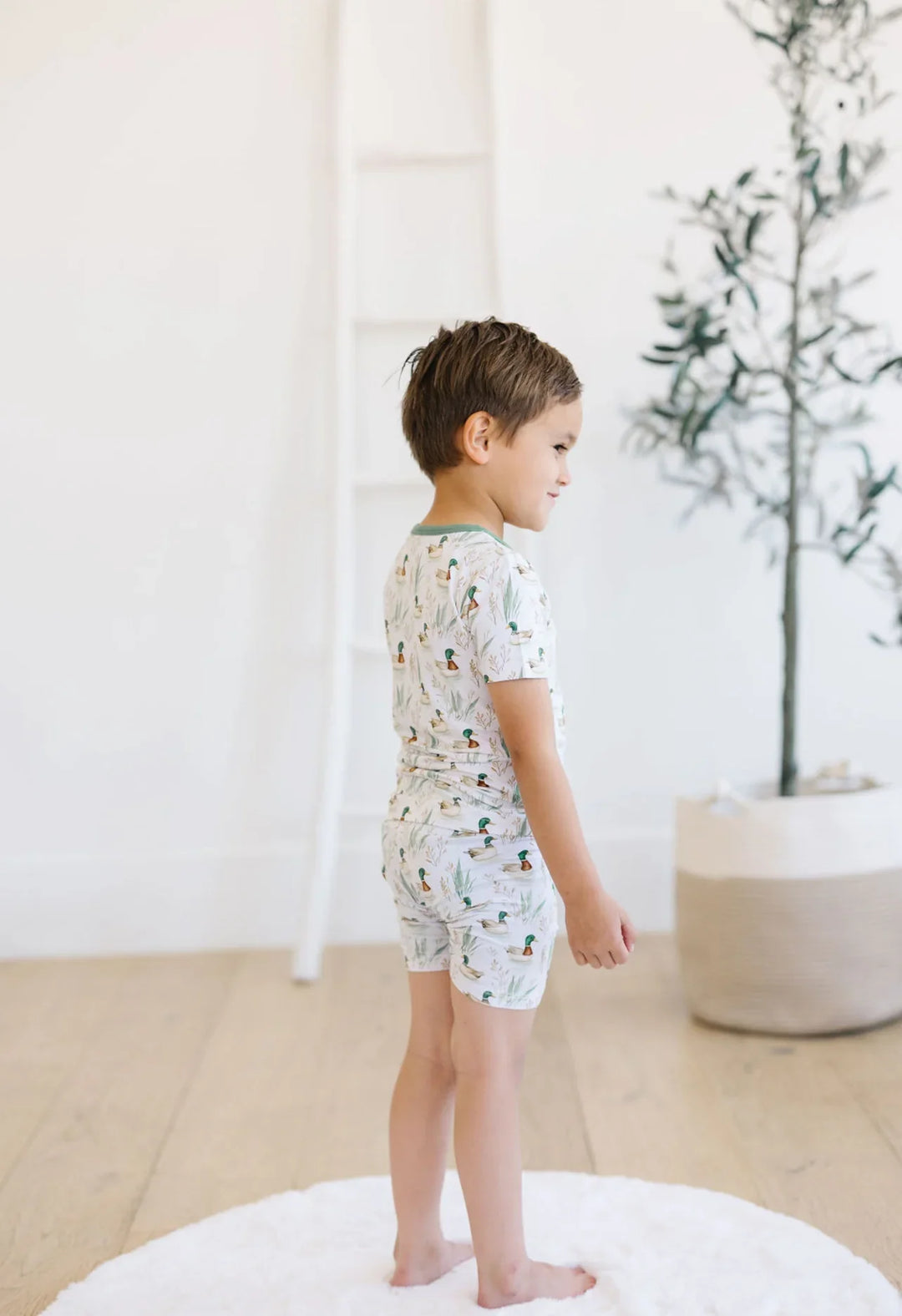 Back view of short sleeve mallard duck pajama top and bamboo shorts worn by toddler boy.