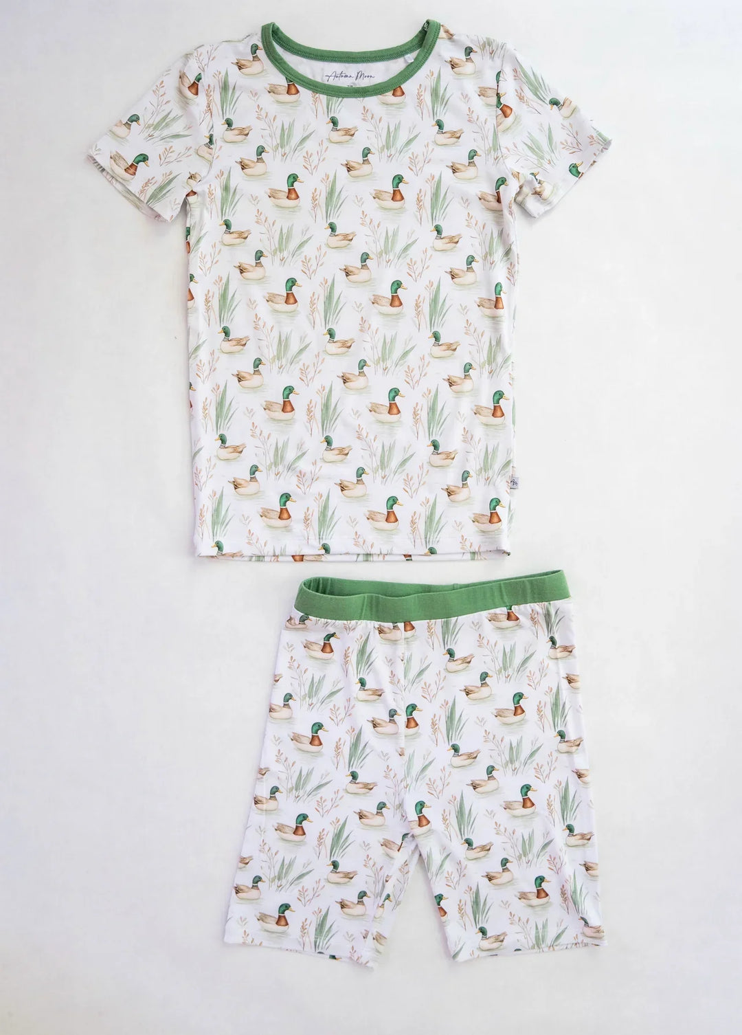 Two-piece kids bamboo pajamas with mallard duck print, short sleeve top and shorts shown flat on white background.