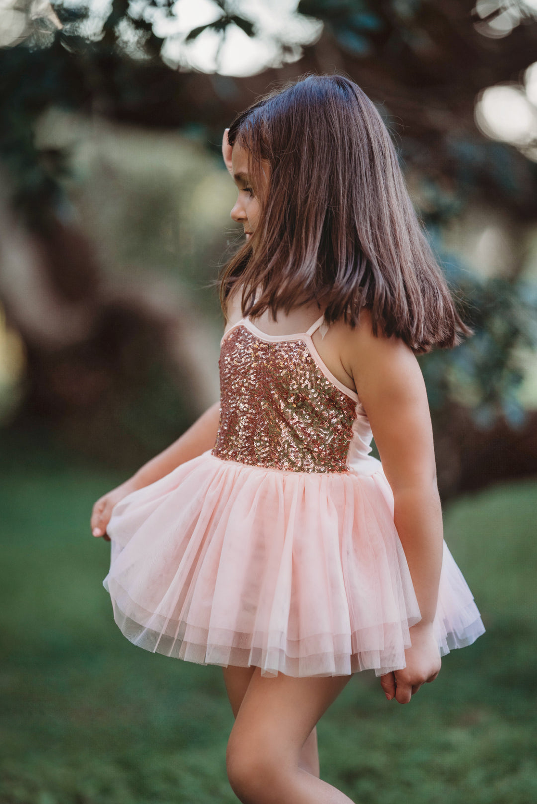 Side angle view of layered blush pink tulle skirt in motion.