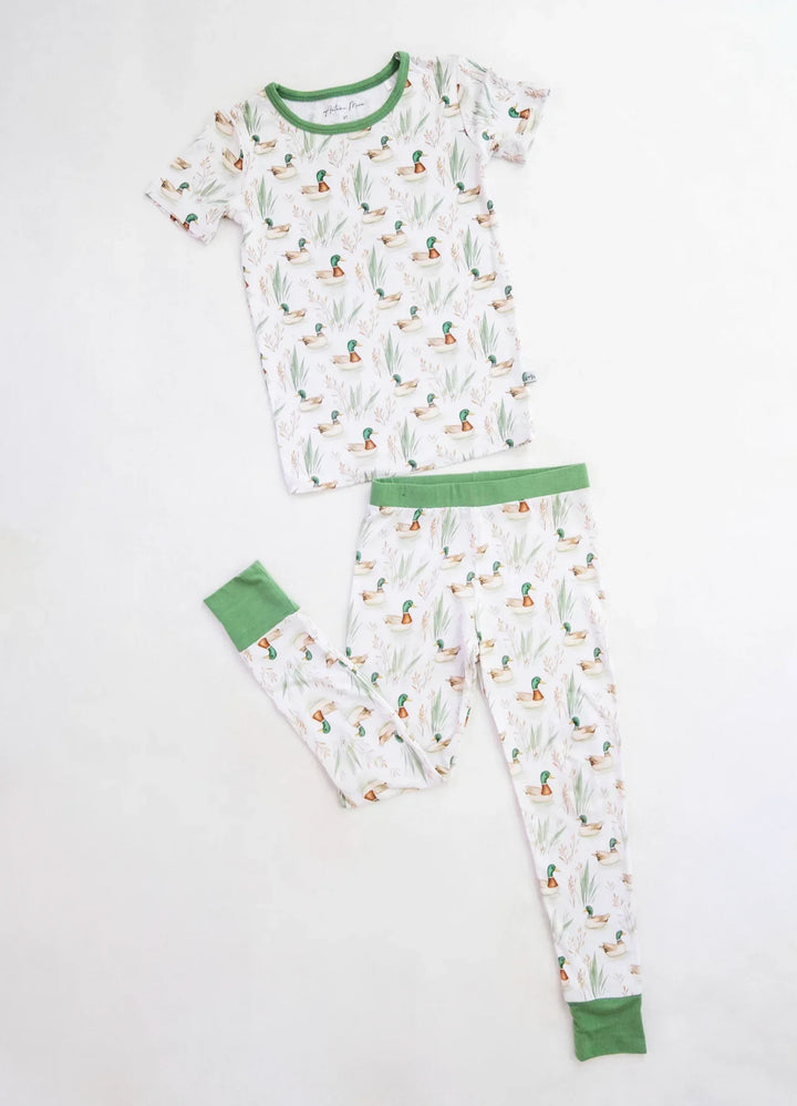 Two-piece kids bamboo pajamas with mallard duck print, short sleeve top and long pants shown in flat lay.