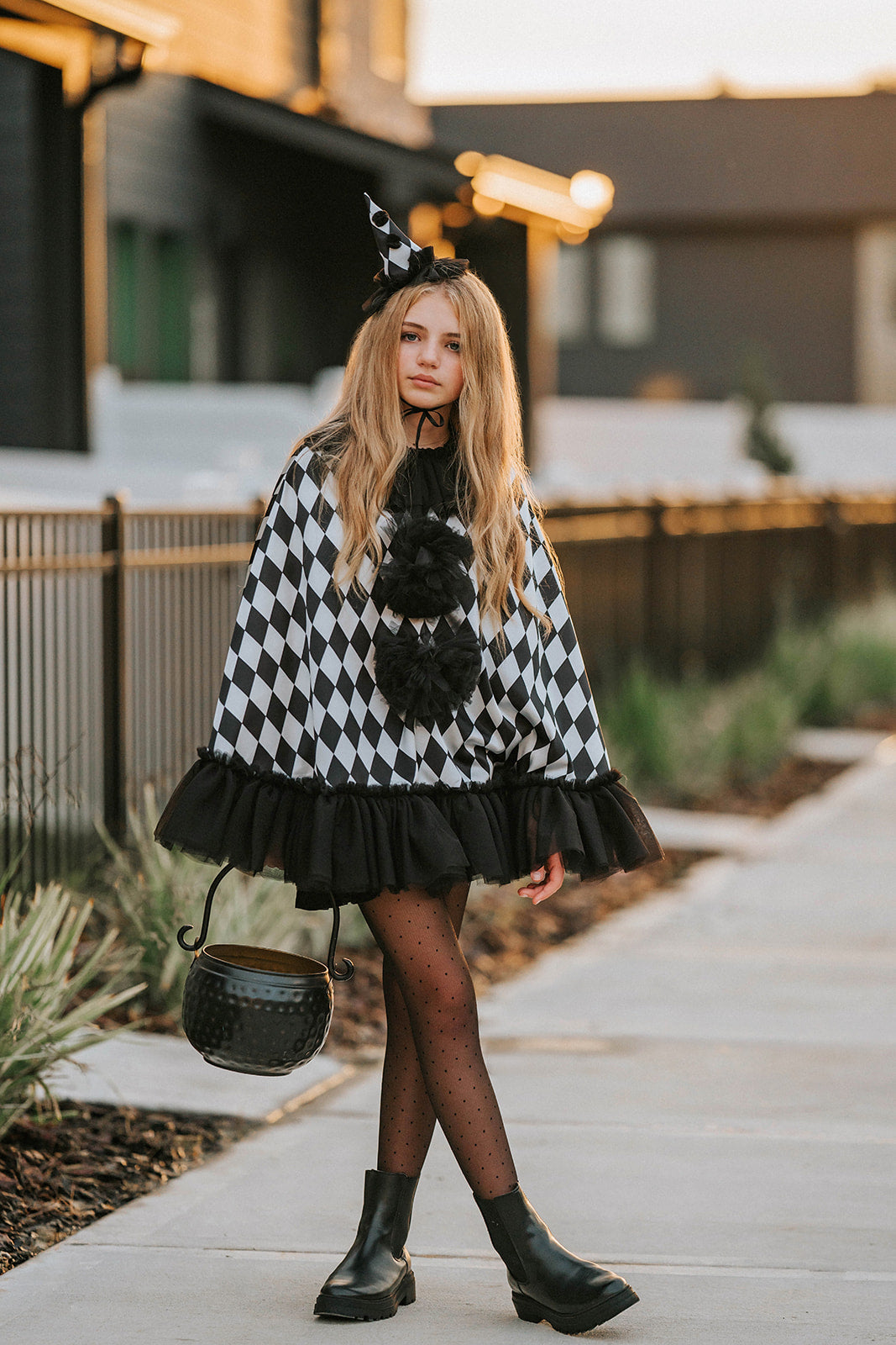 Full-length Pirouette clown costume with black and white harlequin satin cape, tulle trim, pom-poms and matching clown hat.