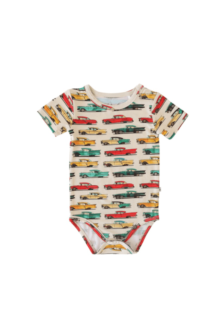Flat lay of classic cars short sleeve baby bodysuit with snap bottom, featuring colorful vintage car print on soft blue bamboo fabric — breathable and gentle on sensitive skin.

