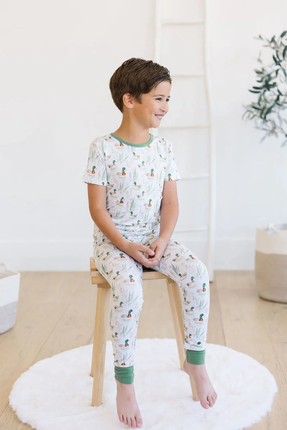 Little boy wearing mallard duck bamboo pajamas, short sleeve top and long pants perfect for bedtime comfort.