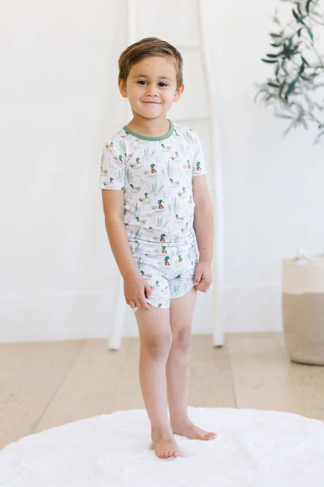 Little boy wearing mallard duck bamboo short sleeve pajama set, styled for summer comfort and play.