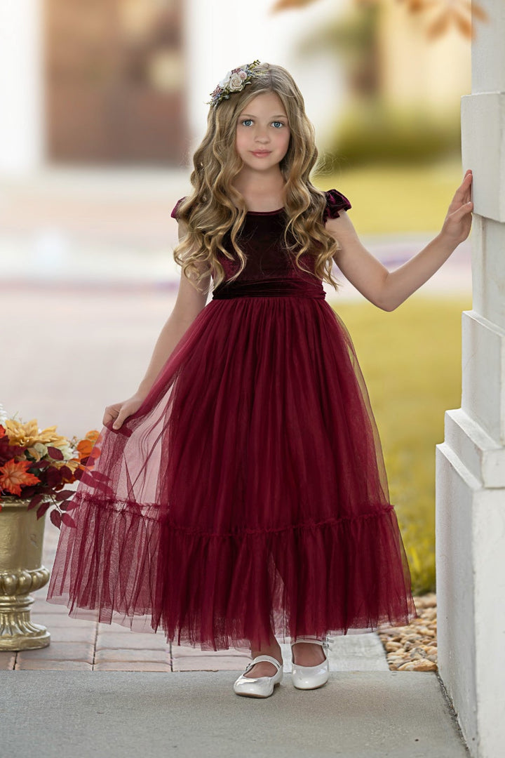 Bordeaux velvet flower girl dress with ruffle sleeves and full tulle skirt, front view outdoors