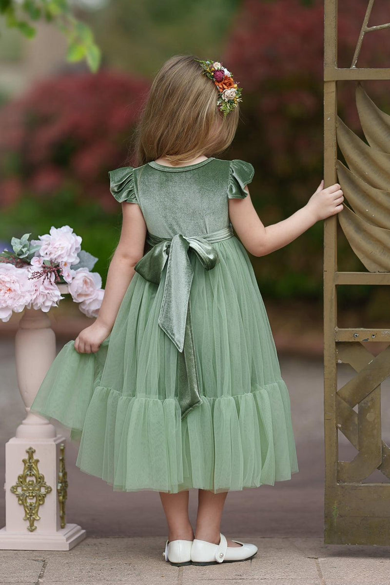 Back view of Marcella sage green velvet flower girl dress showing full bodice, sash, and soft tulle layers