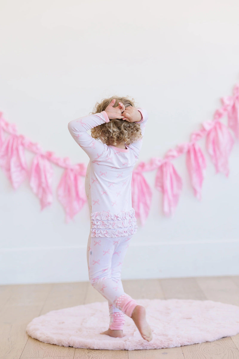 Back view of pink bows long sleeve bamboo zipper pajamas for baby or toddler, showing full footie coverage.
