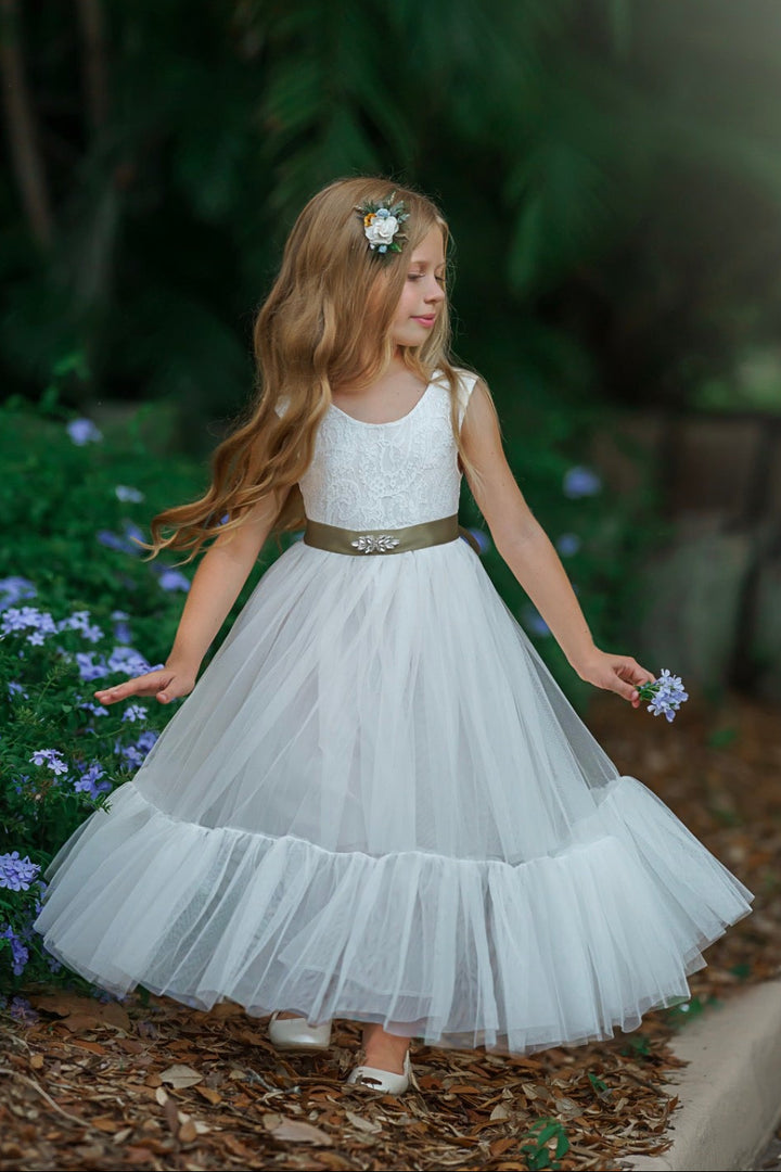 Soft white sleeveless lace flower girl gown with flowing layered tulle photographed outdoors