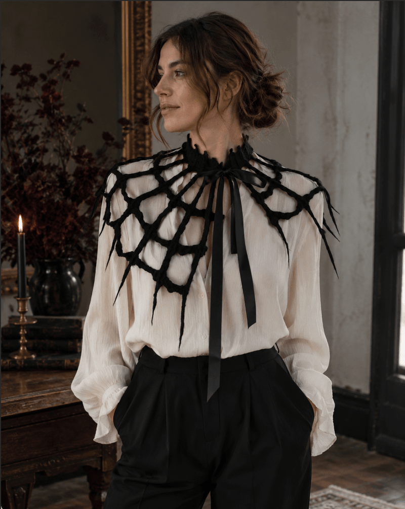 Woman wearing Midnight Black spiderweb capelet over a Halloween outfit