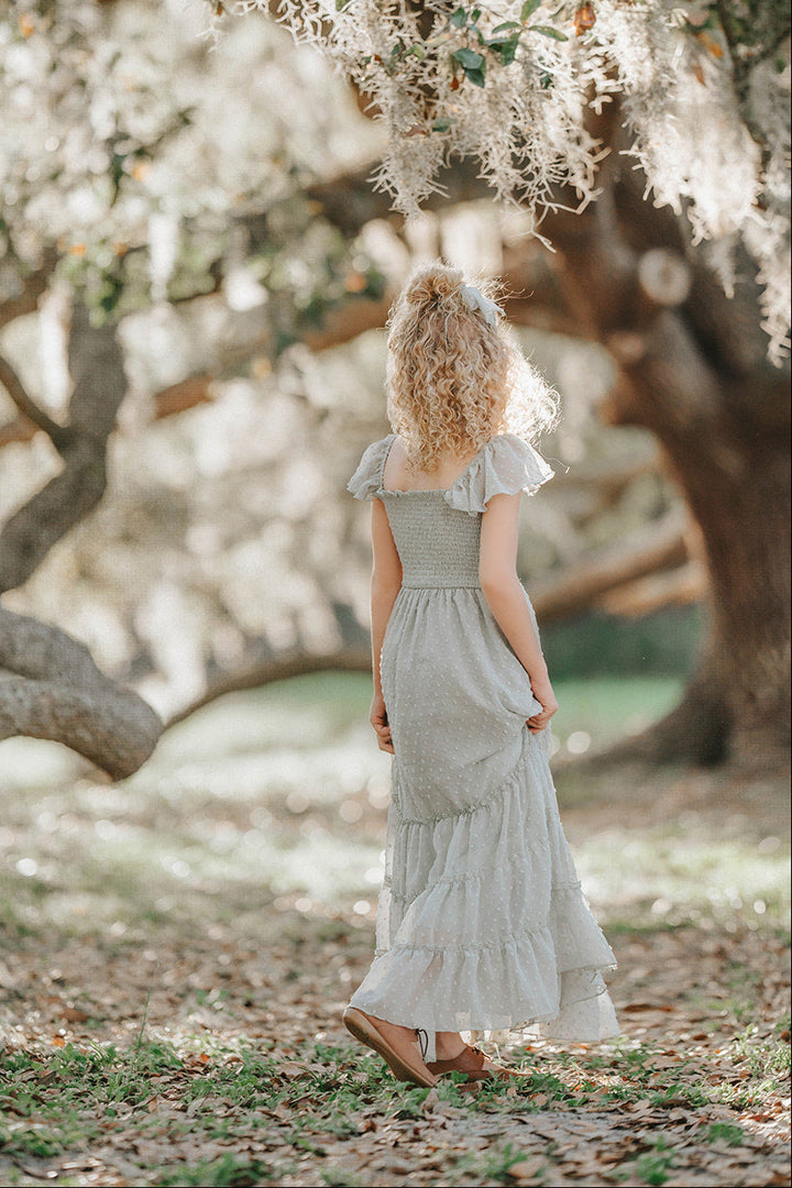 Back view of the Bay Leaf Orchard Collection dress showing the smocked bodice and flowing Swiss dot tiers.