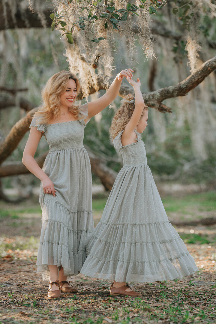 Mother and daughter wearing matching Bay Leaf Swiss dot dresses from the Orchard Collection by Autumn Moon.