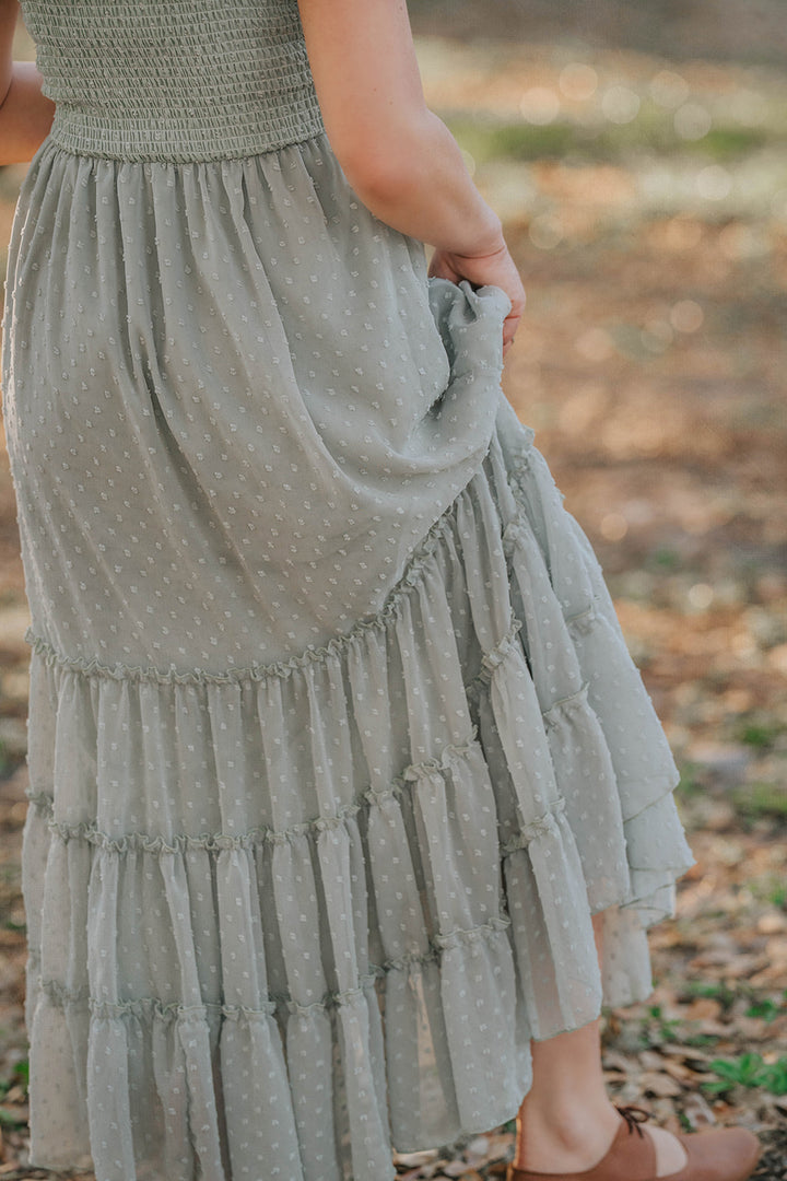 Close-up of the Bay Leaf Swiss dot maxi dress fabric and tiered ruffle skirt detail.