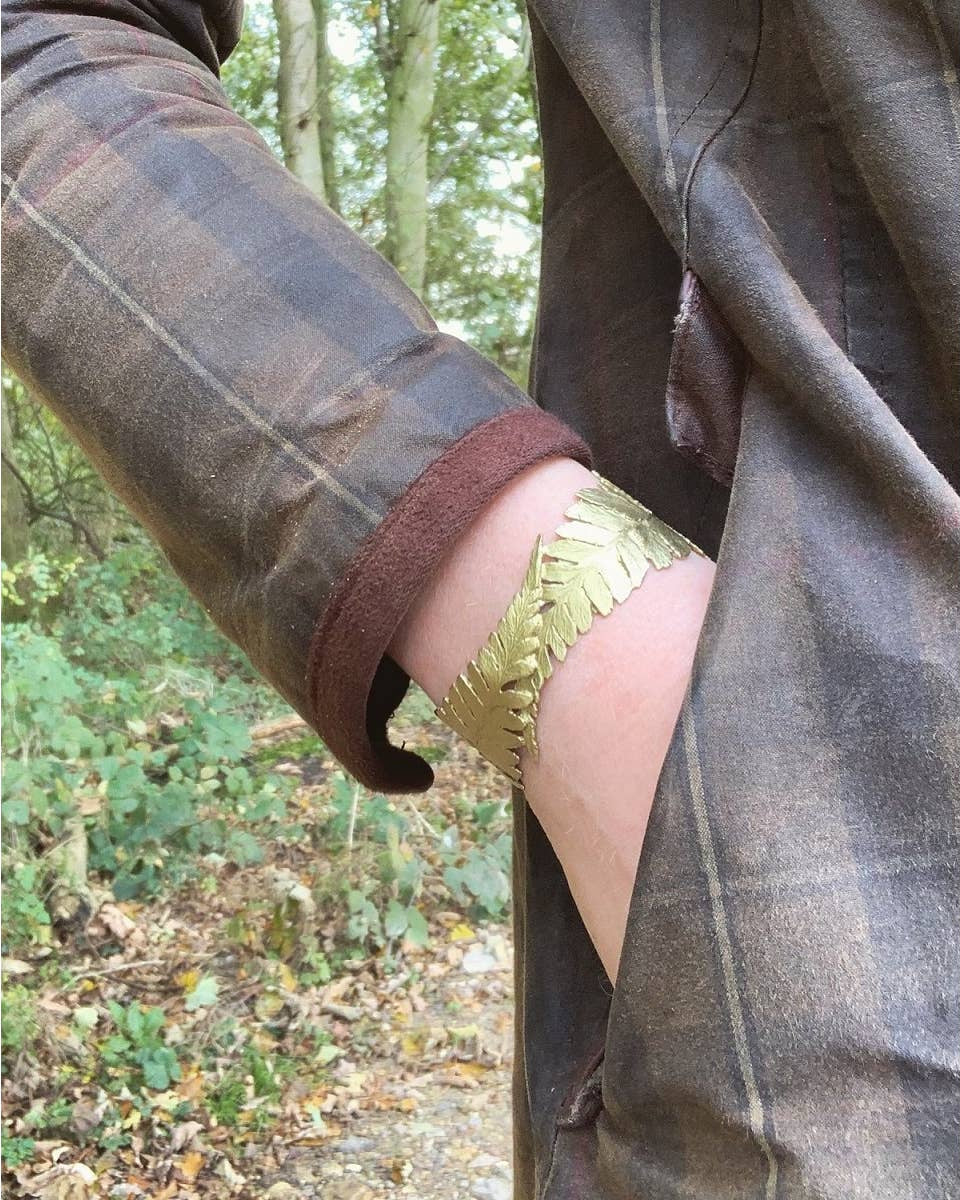 Fern Cuff Bracelet worn on wrist showcasing elegant bronze fern fronds and artisan botanical craftsmanship