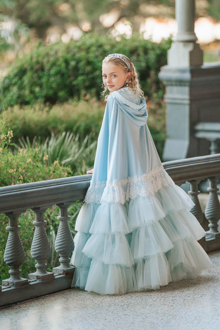 Girl wearing The Cendrillon pale blue satin princess cape from the back, showing lace trim and cascading tulle ruffles