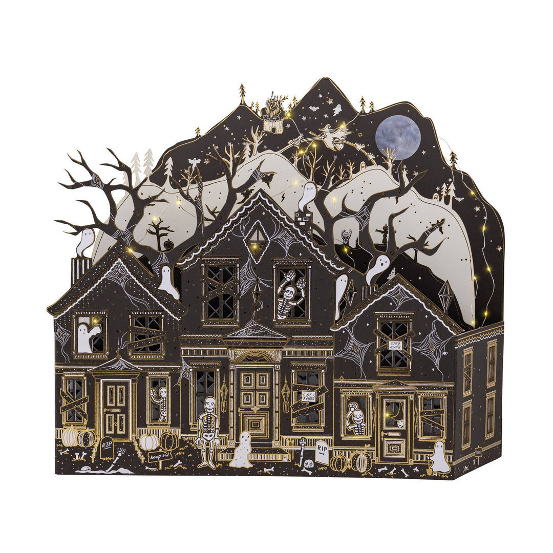 Detailed haunted paper house featuring ghosts, skeletons, pumpkins, cobwebs, and gold foil accents.
