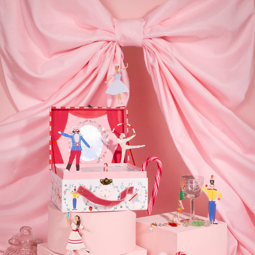 New York City Ballet Nutcracker Advent Calendar displayed with pink Christmas décor and charm bracelet