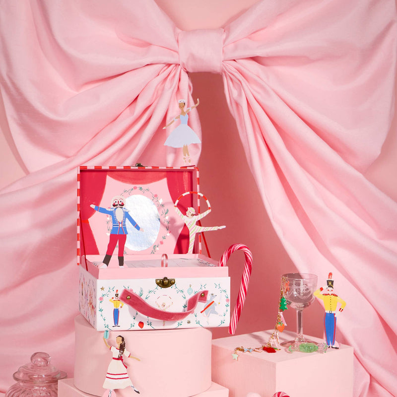 New York City Ballet Nutcracker Advent Calendar displayed with pink Christmas décor and charm bracelet