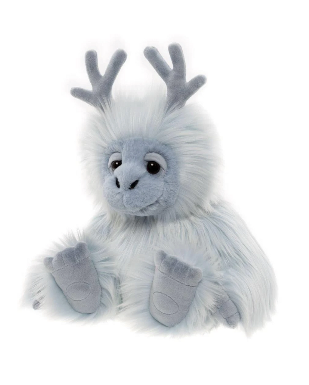 Oomph yeti stuffed animal seated at an angle, showing fluffy blue fur with white tips and oversized padded paws