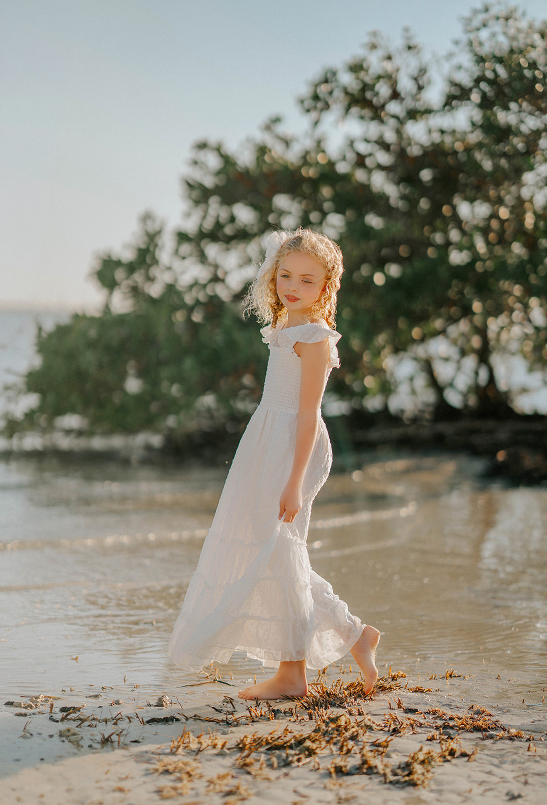 Girl running and twirling in the Orange Blossom Orchard Collection dress designed for movement and special occasions.