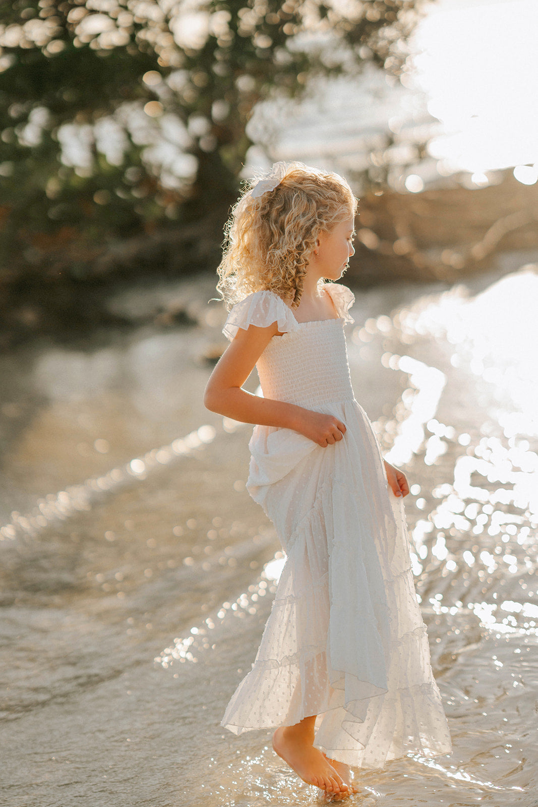Side view of the Orange Blossom Orchard Collection girls dress showing its flowing silhouette and tiered skirt.