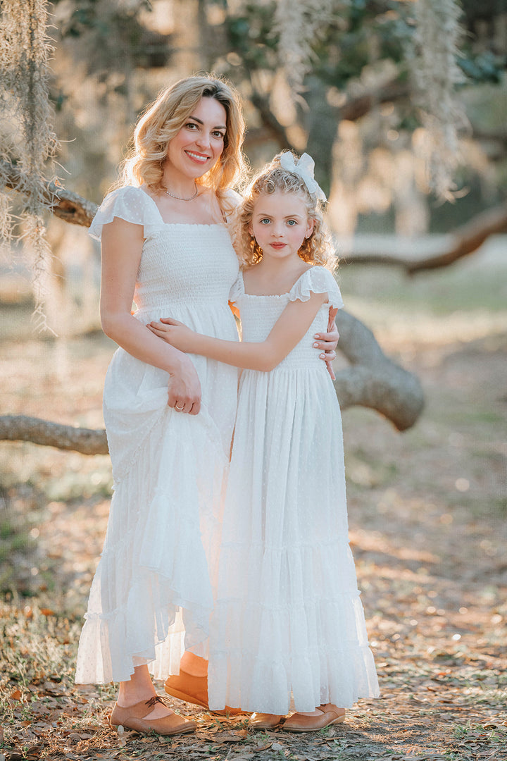 Mother and daughter wearing matching Orange Blossom Swiss dot dresses from the Orchard Collection by Autumn Moon.