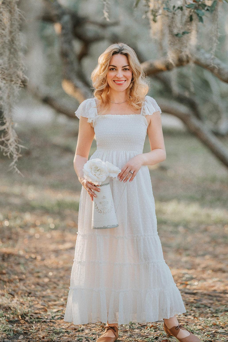 Full-length view of the Orange Blossom Swiss dot maxi dress featuring a smocked bodice and flowing tiered skirt.