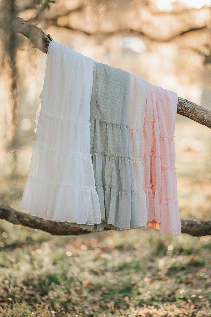 Orchard Collection Swiss dot dresses displayed in Citrus Cream, Orange Blossom, Bay Leaf, and Wild Strawberry colorways