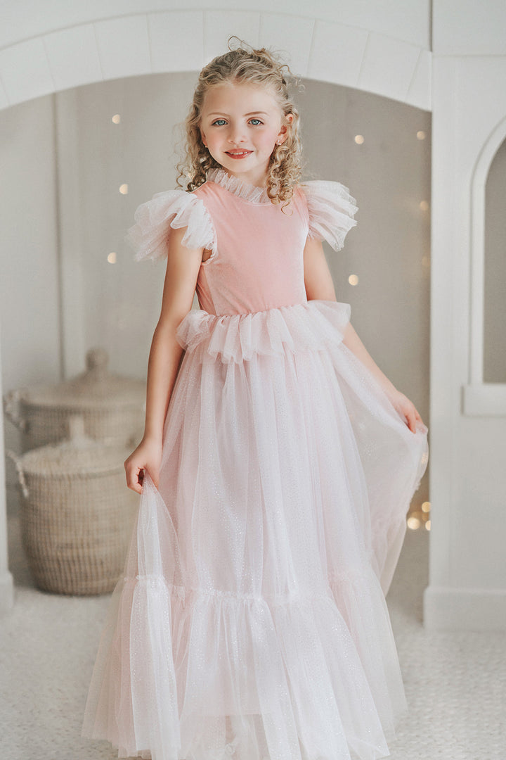 Sparkling pink princess dress for girls with soft velvet bodice and flowing tulle skirt for fairy tale dress up.