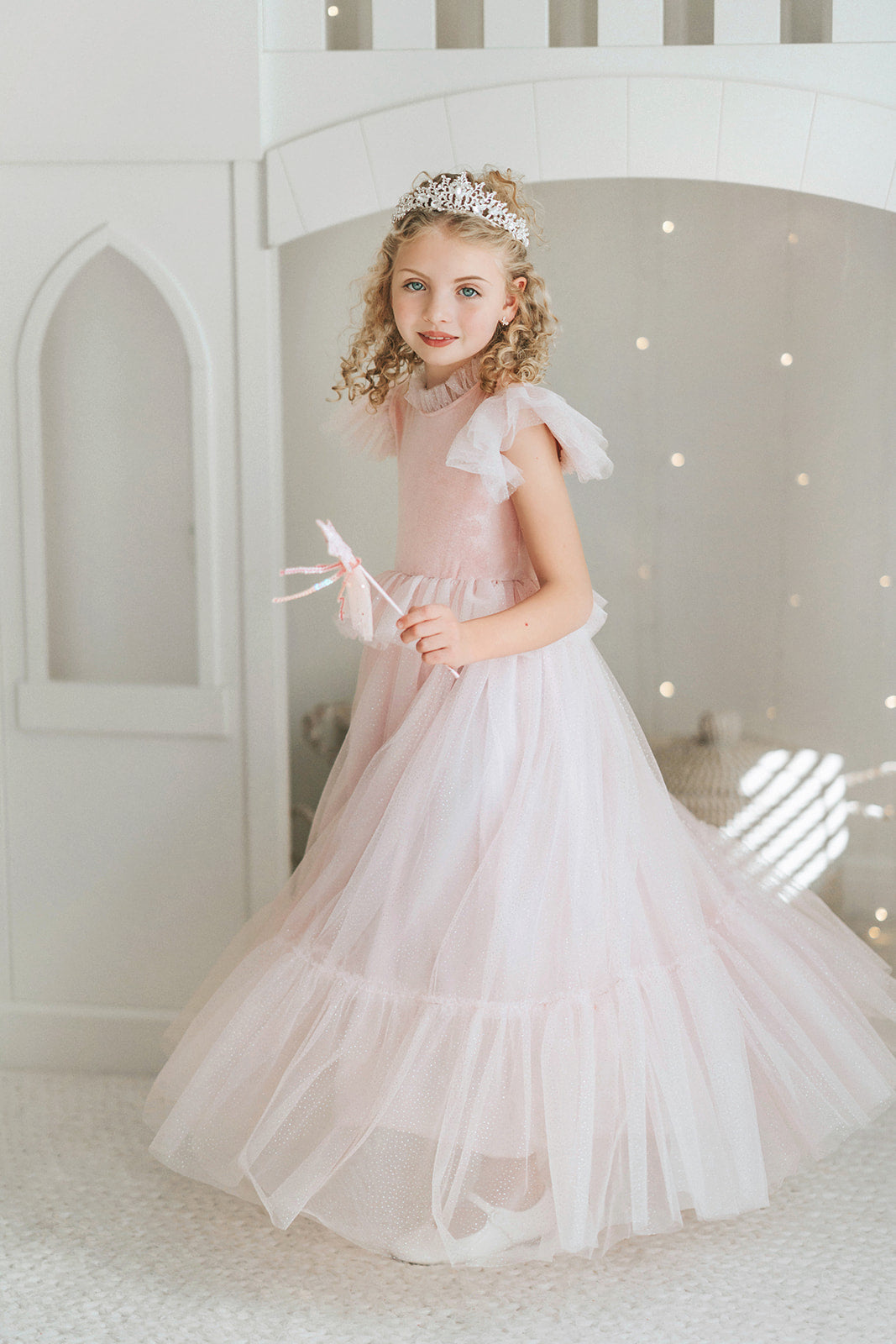 Twirling girls princess dress in blush pink velvet with sparkling tulle skirt for birthdays, holidays, and imaginative play.