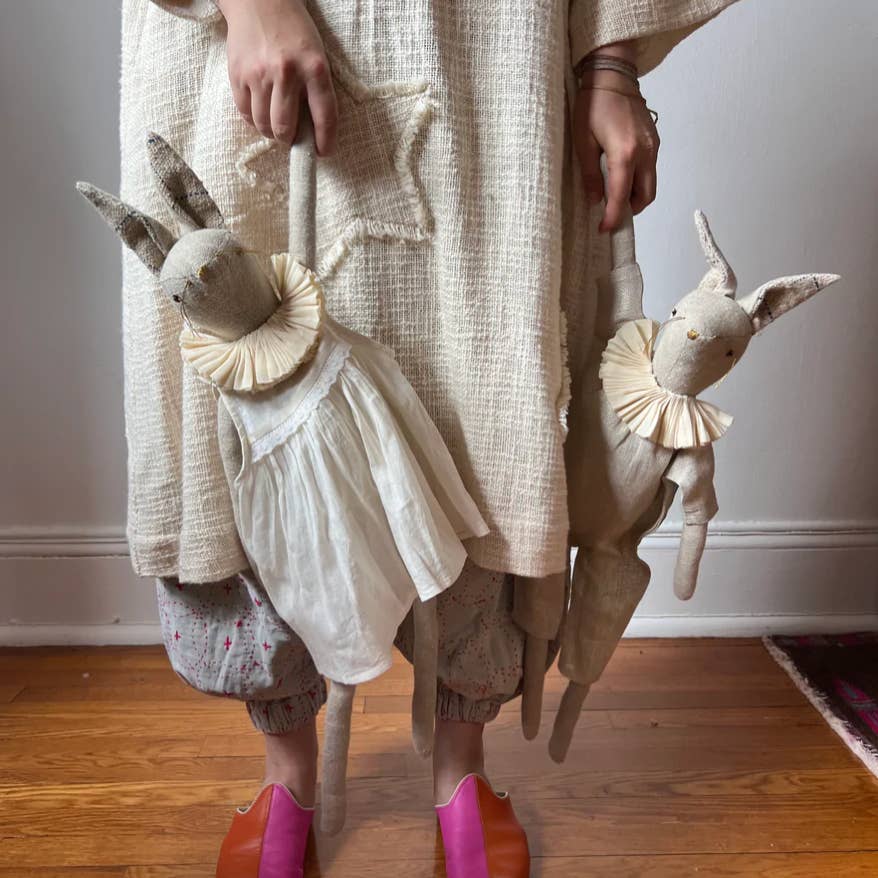 Decorative linen bunny ragdoll in a cotton dress styled as whimsical nursery décor