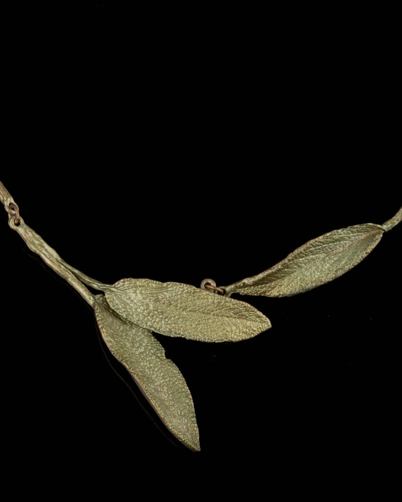 zoomed-in detail:
Michael Michaud Sage Necklace close-up featuring hand-patinated bronze sage leaves with botanical texture and sculptural detail
