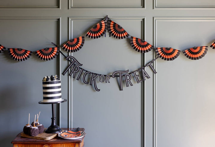 Trick or Treat Halloween banner decorating an entryway with black stars, crescent moon and seasonal accents