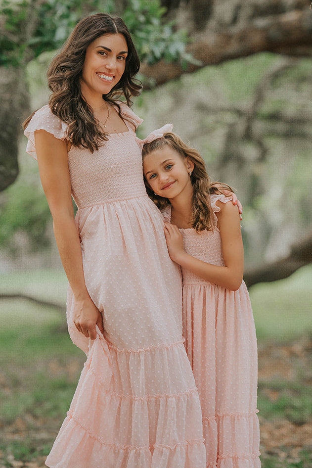 Mother and daughter wearing matching Wild Strawberry Swiss dot dresses from the Orchard Collection.