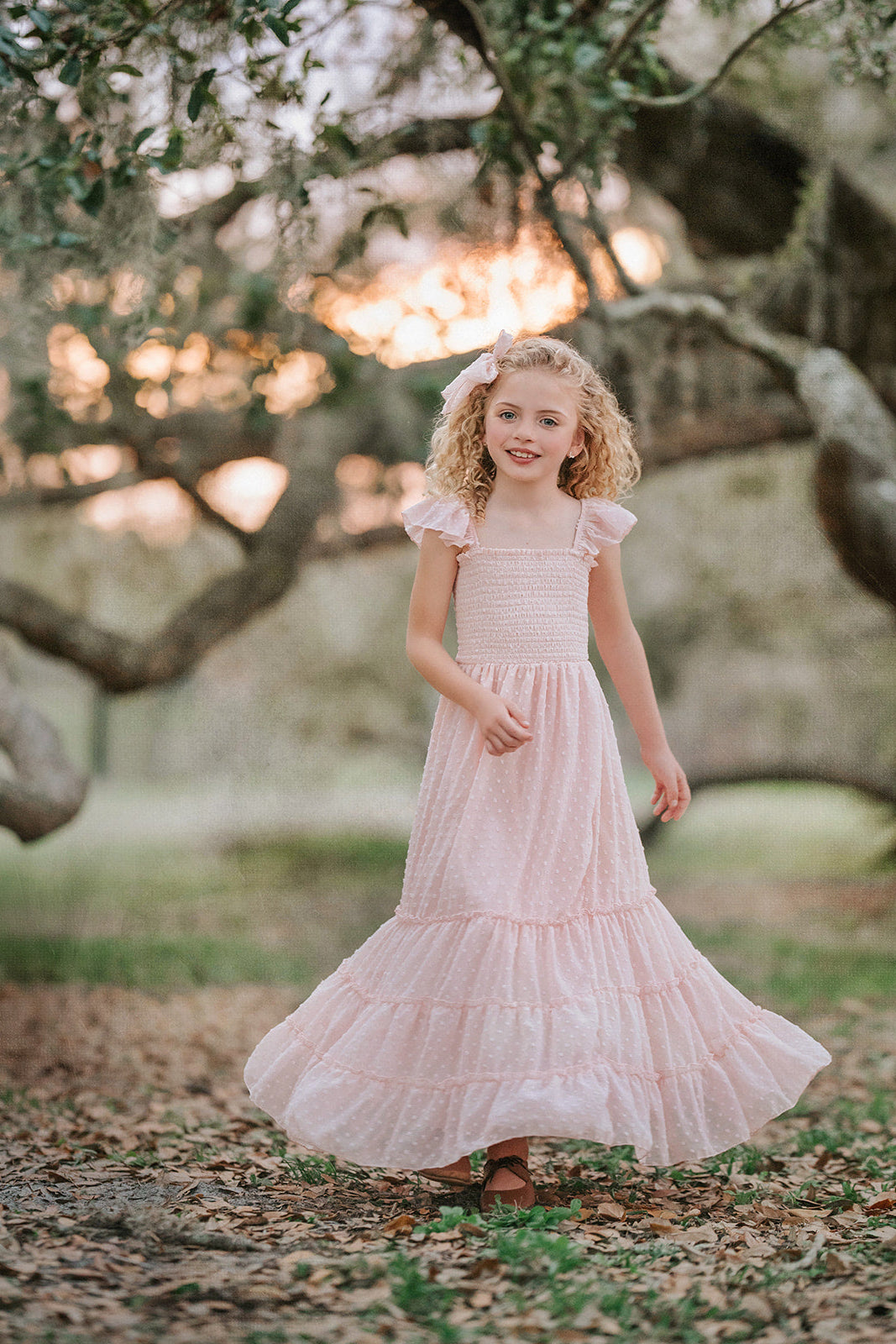 Back view of Wild Strawberry Swiss dot girls dress showing flowing skirt and smocked bodice