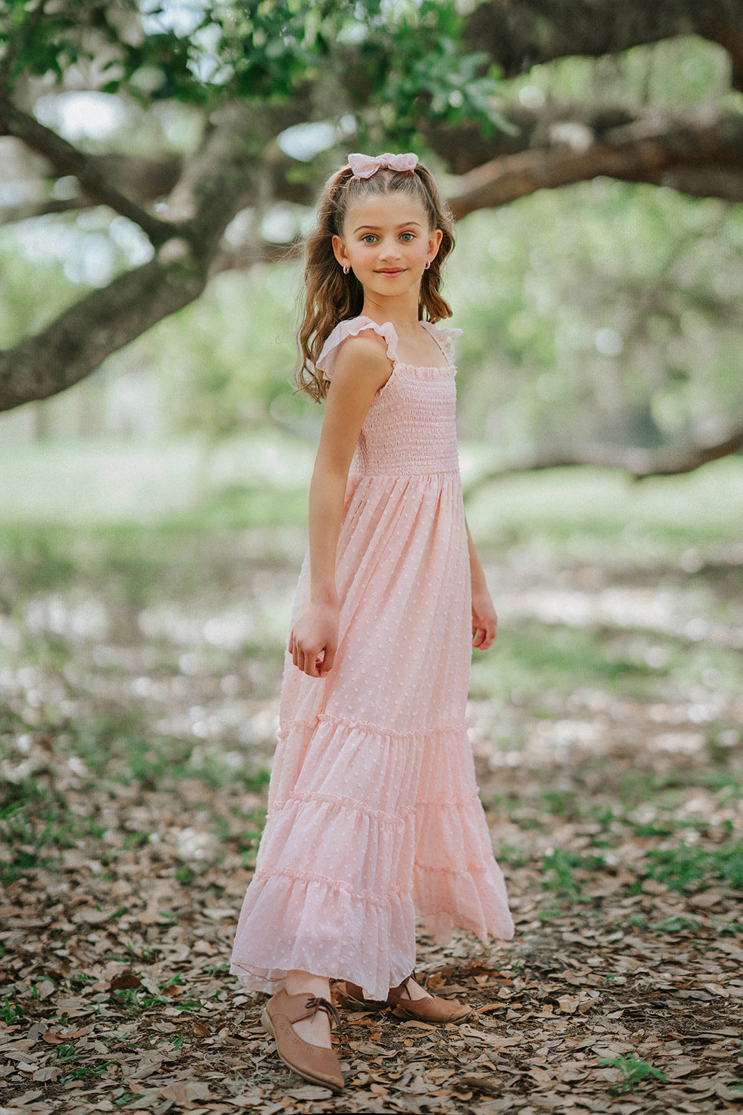 Side profile of Wild Strawberry Swiss dot girls dress showcasing flutter sleeves and flowing skirt