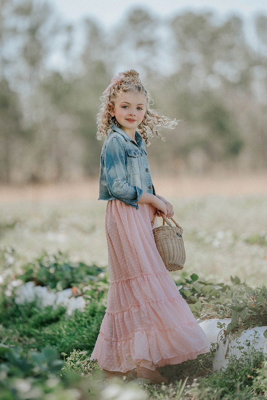 Girl twirling in Wild Strawberry Swiss dot maxi dress with tiered ruffle skirt