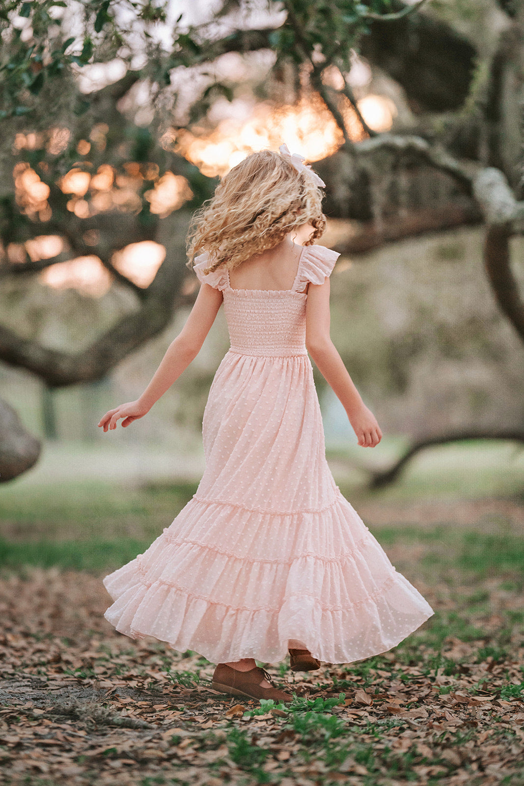 Wild Strawberry Swiss dot girls dress in motion showing the flowing tiered silhouette