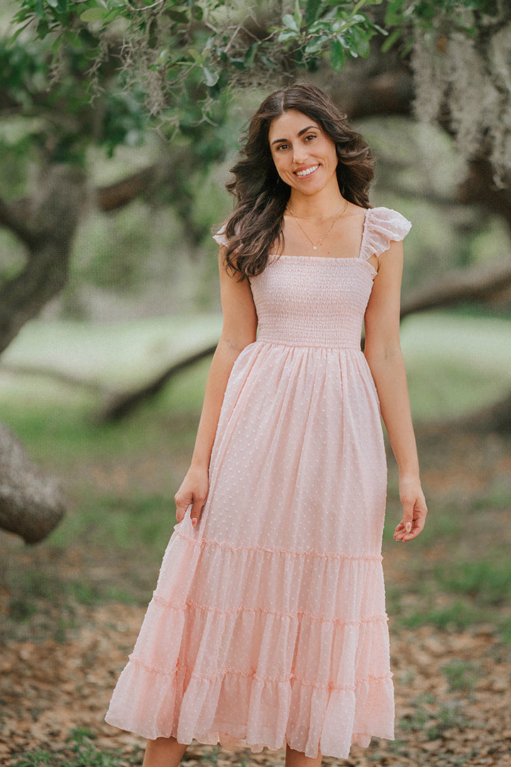Full-length view of the Wild Strawberry Swiss dot maxi dress featuring a smocked bodice and flowing tiered skirt.