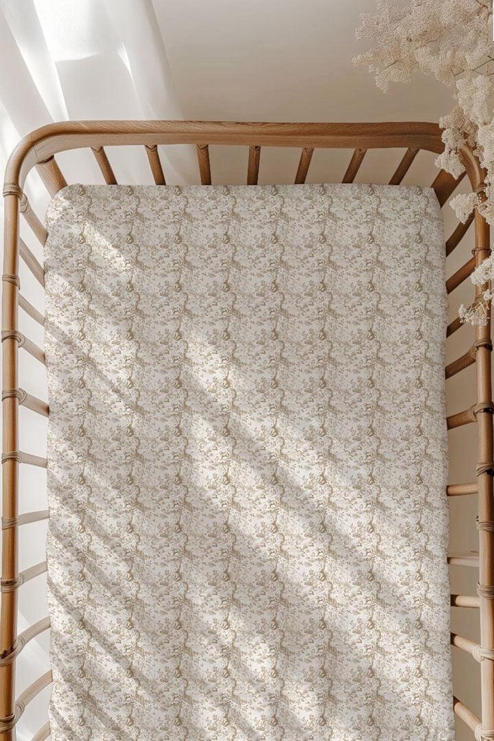 Woodland Toile bamboo crib sheet on standard size crib mattress, featuring brown forest animals like bears and deer on soft ivory fabric — unisex nursery bedding.
